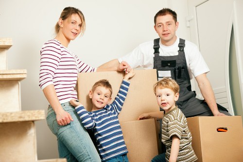 Removal van and movers planning access on a residential Finchley street